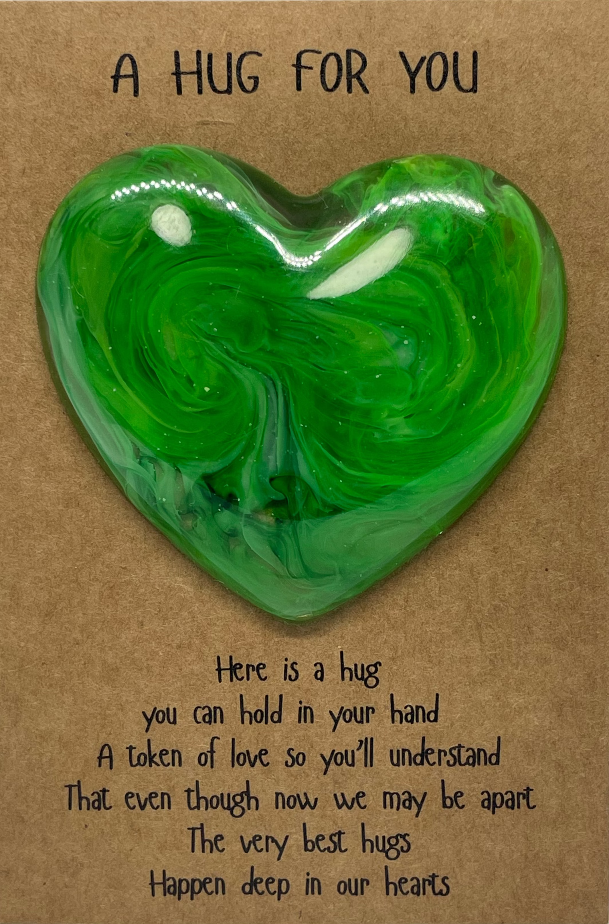Heart-shaped green Heart Hug on a brown card with text
