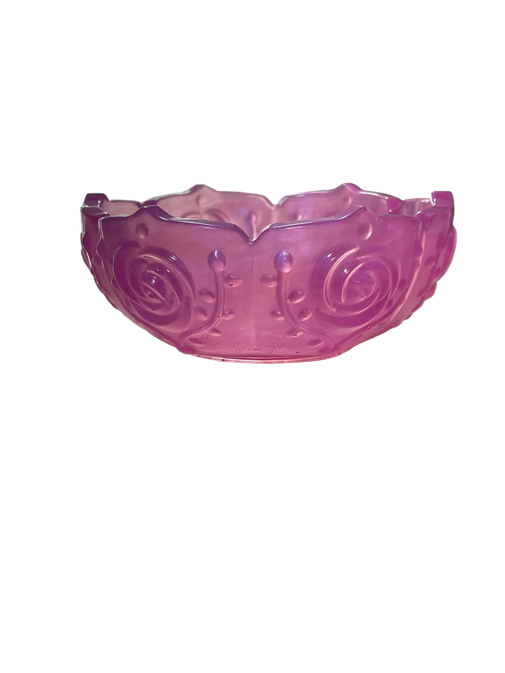 Pink resin bowl on a surface with a blurred background