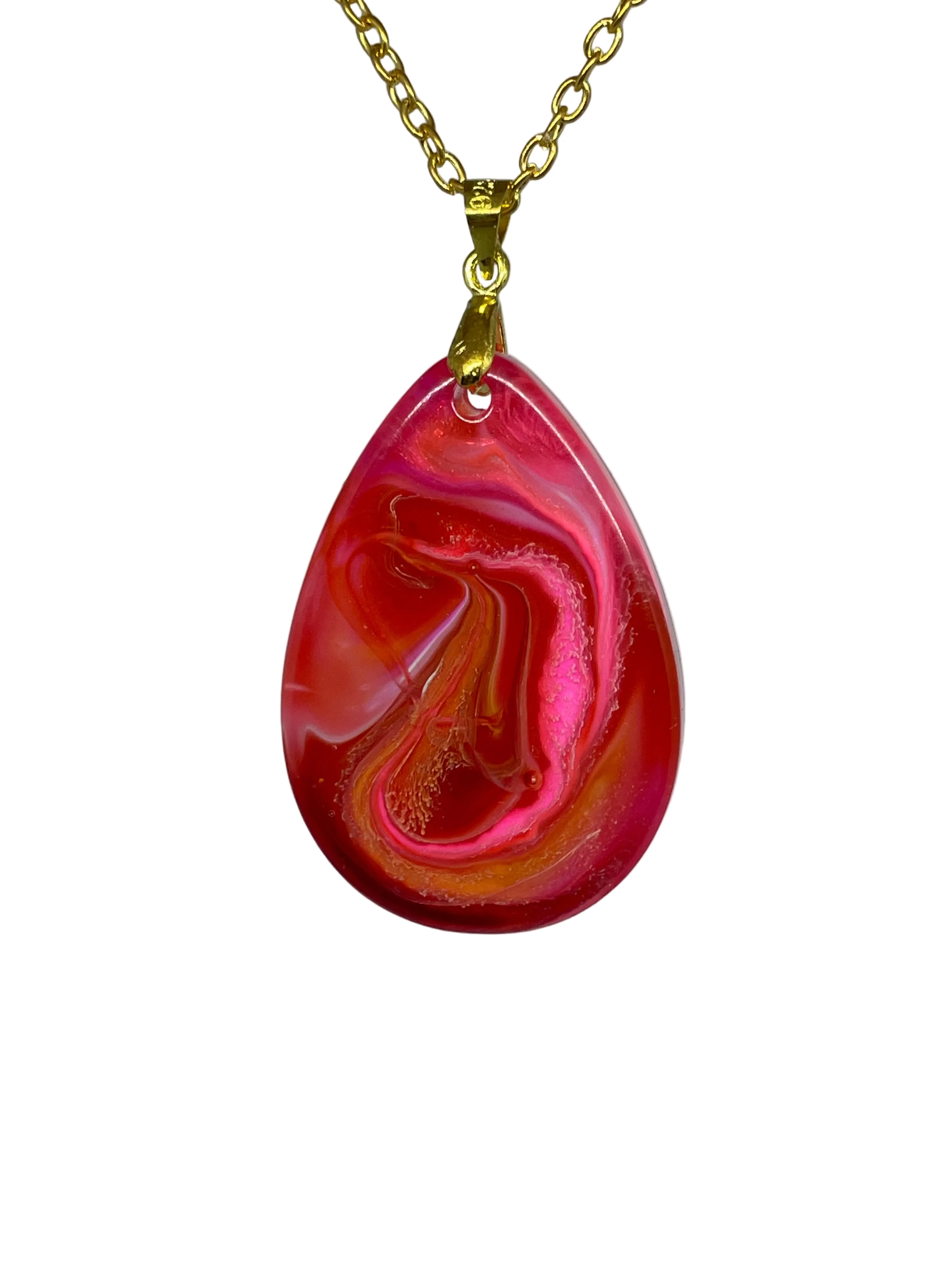 Teardrop-shaped pendant with red and pink swirl design on a gold chain against a gray background