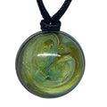 Necklace with a round pendant featuring a green and yellow marbled design on a white background.
