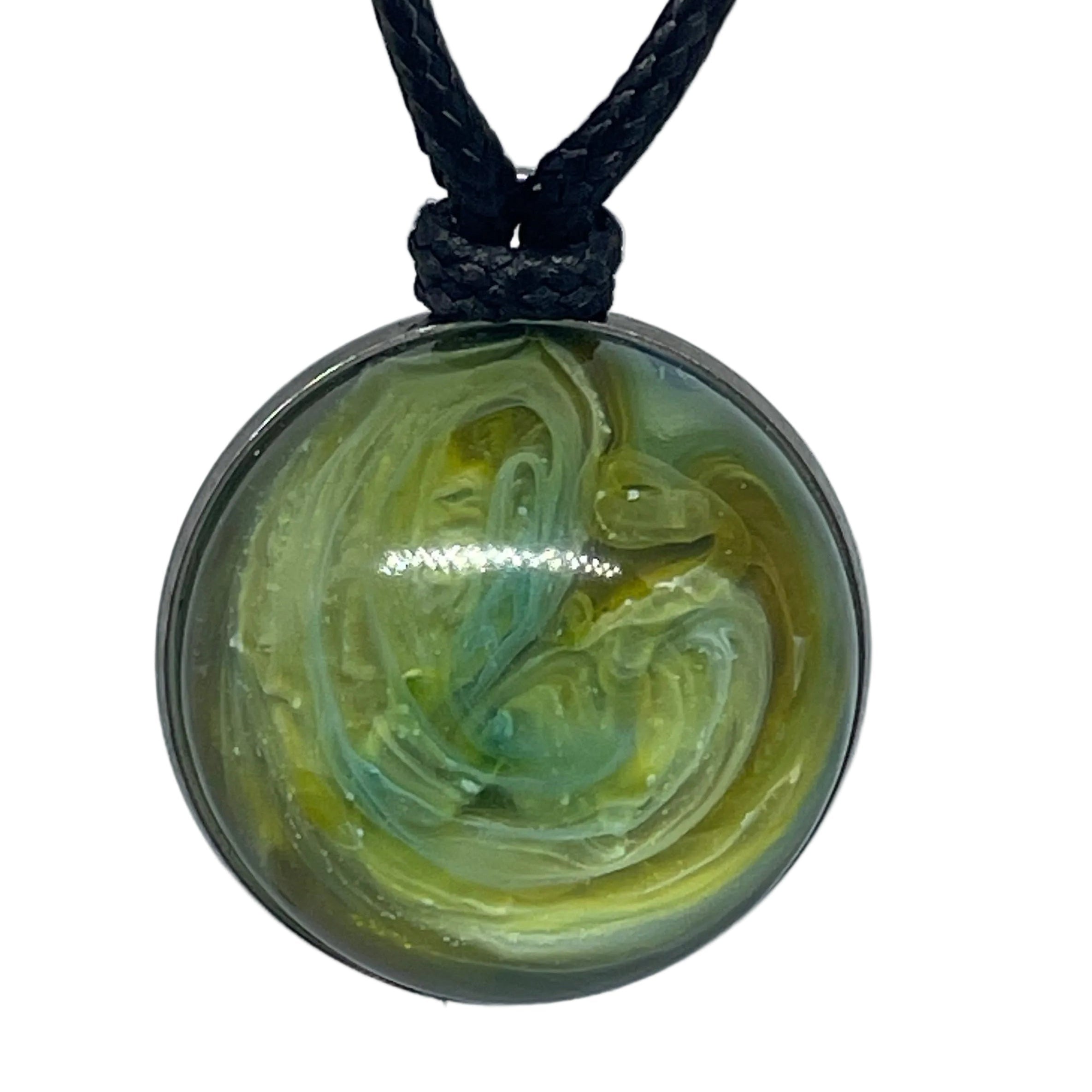 Necklace with a round pendant featuring a green and yellow marbled design on a white background.