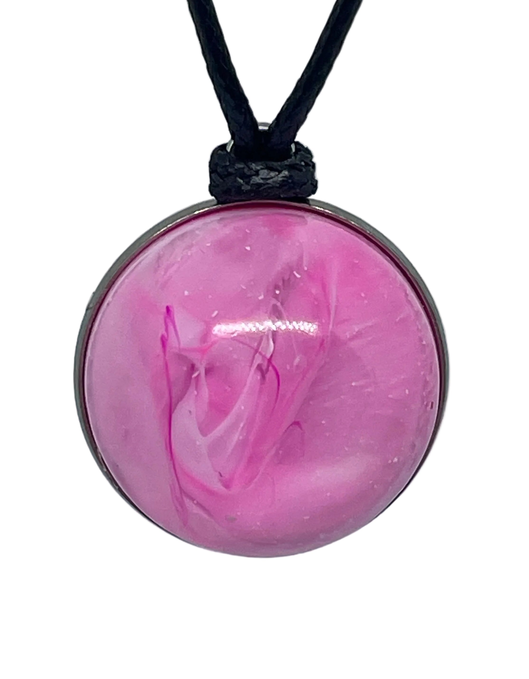 Pink resin pendant on a black cord against a white background
