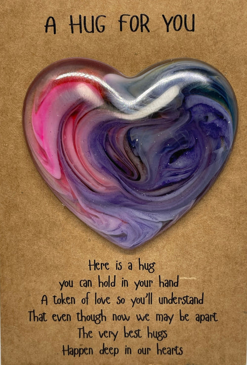 Heart-shaped hug pillow with text on a cardboard backing