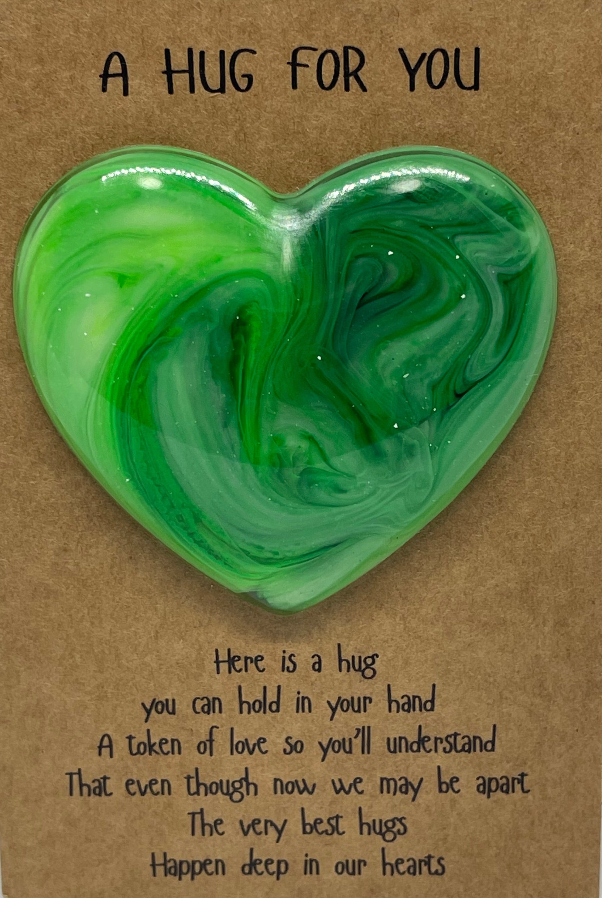 Heart-shaped green object on a cardboard box with text