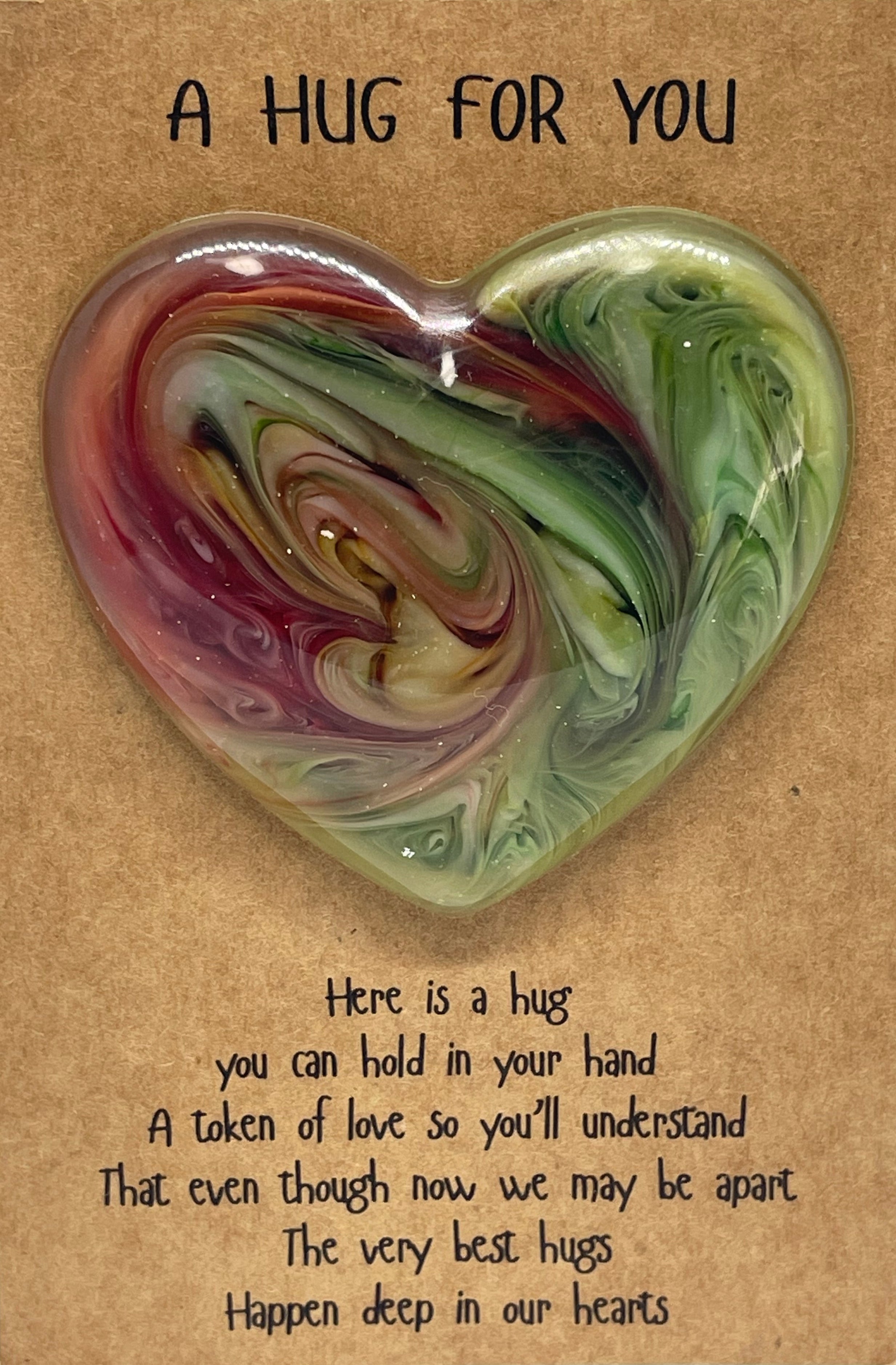 Heart-shaped hug pillow with text on a cardboard backing