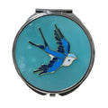 Compact mirror with a blue bird design on a light blue background